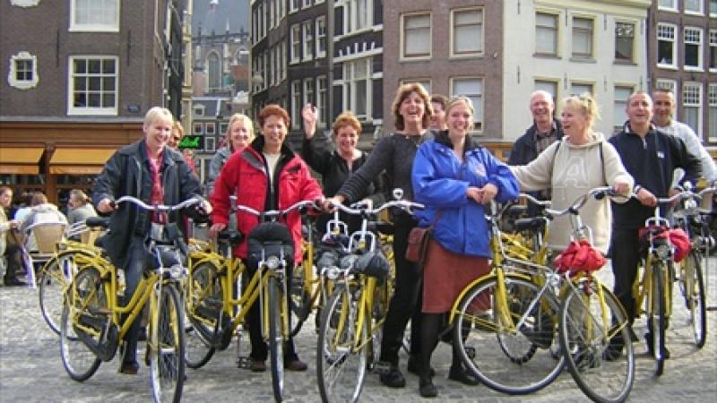 Group is enjoying from bike tour in Amsterdam